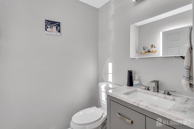 bathroom featuring vanity and toilet