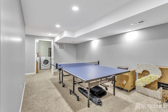 game room with light colored carpet and washer and dryer