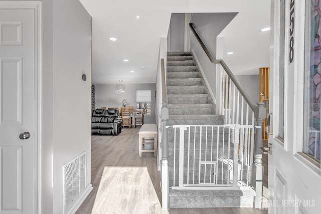 stairway with hardwood / wood-style floors