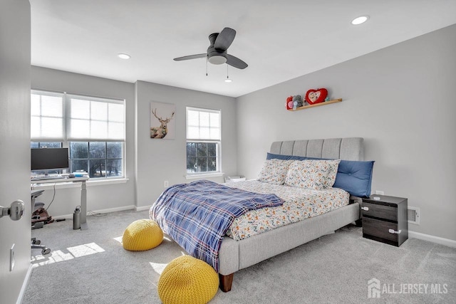 bedroom featuring light colored carpet and ceiling fan