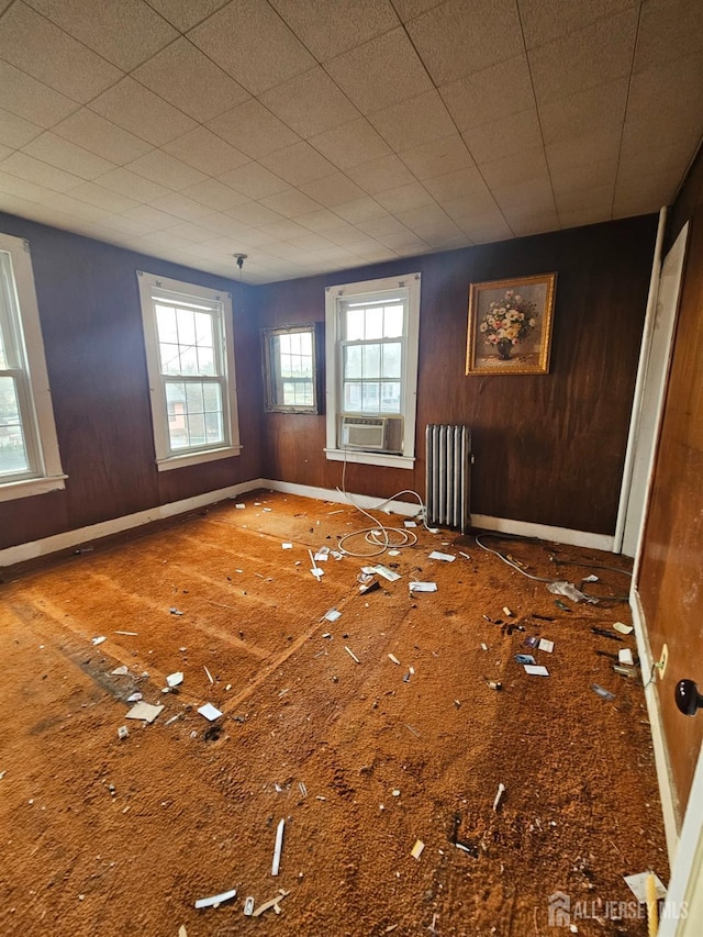 empty room with radiator and baseboards