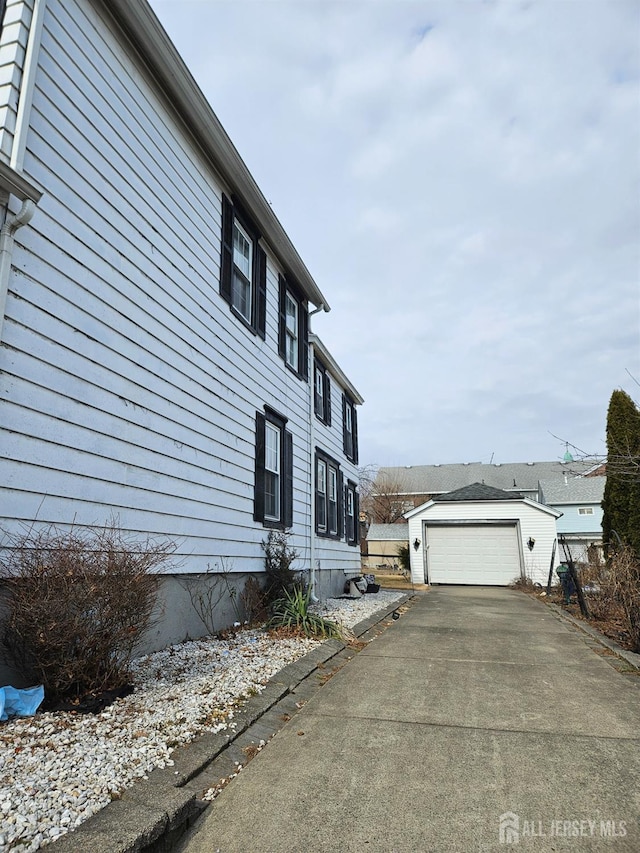 view of side of property featuring a garage and an outdoor structure