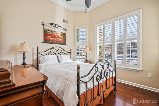 bedroom with ornamental molding, ceiling fan, dark hardwood / wood-style flooring, and multiple windows