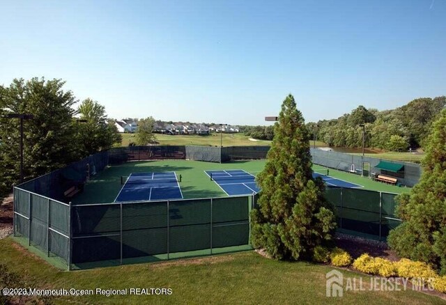 view of sport court with a yard