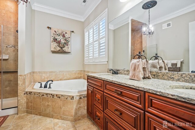 bathroom with shower with separate bathtub, tile patterned flooring, ornamental molding, vanity, and a chandelier