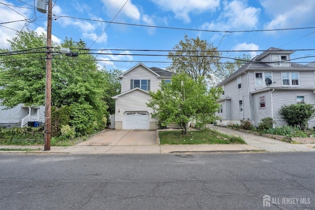 view of front of house with concrete driveway and an attached garage
