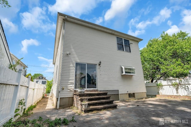 back of house featuring a patio, fence, and entry steps