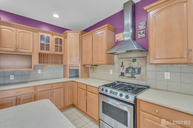 104 George St, South River, NJ 08882 - kitchen featuring wall chimney range hood, stainless steel range with gas stovetop, light countertops, backsplash, and glass insert cabinets