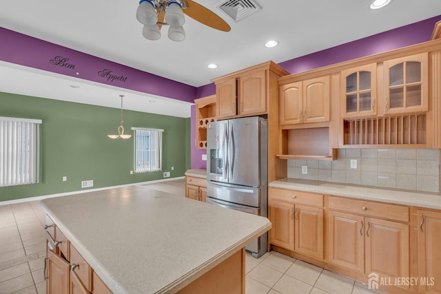 kitchen featuring ceiling fan, visible vents, open shelves, light tile patterned floors, and stainless steel fridge