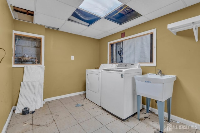 laundry room with baseboards, laundry area, and washer and dryer