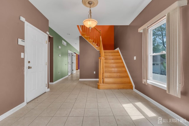 stairway featuring baseboards and tile patterned flooring