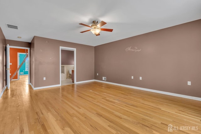 unfurnished room with visible vents, a ceiling fan, baseboards, and light wood-type flooring