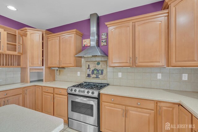104 George St, South River, NJ 08882 - kitchen featuring gas range, wall chimney exhaust hood, light countertops, light brown cabinetry, and backsplash