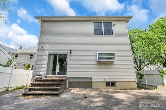 back of house with a patio, fence, and entry steps