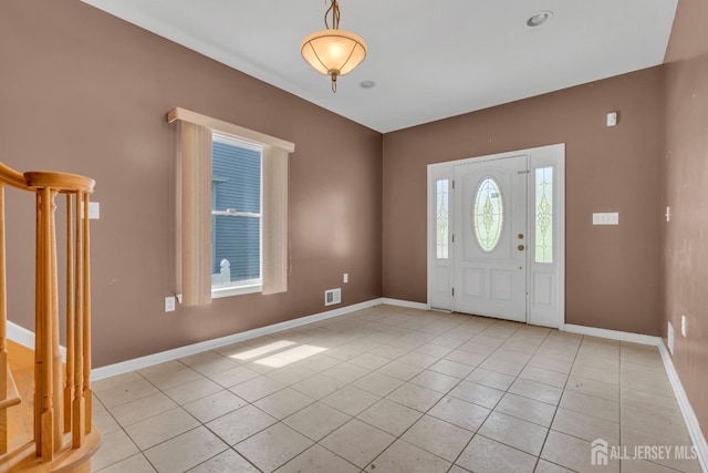 entryway featuring light tile patterned floors and baseboards