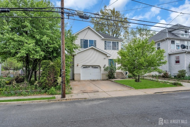 view of front of home featuring concrete driveway and an attached garage