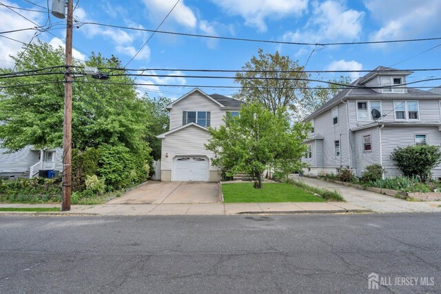 104 George St, South River, NJ 08882 - view of front of property featuring a garage and concrete driveway