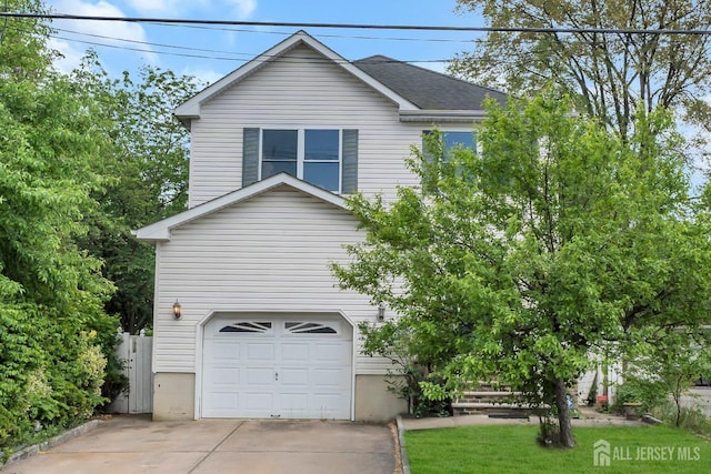 view of front facade featuring concrete driveway and a garage