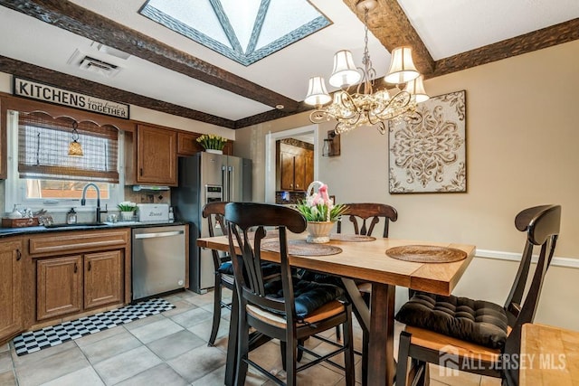 dining area featuring visible vents, beam ceiling, a skylight, light tile patterned flooring, and a chandelier