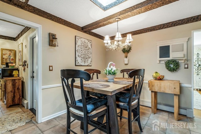 dining area featuring beam ceiling, an inviting chandelier, a skylight, light tile patterned floors, and baseboards