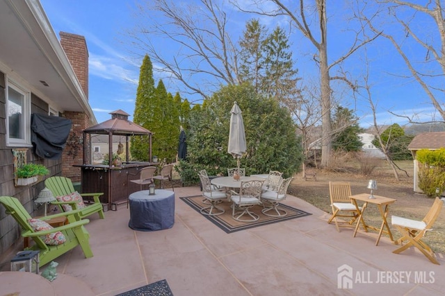 view of patio / terrace featuring a gazebo and outdoor dining area