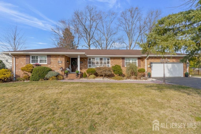 ranch-style house featuring brick siding, a front lawn, an attached garage, and driveway