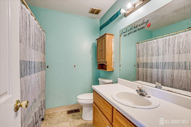 bathroom featuring toilet and vanity