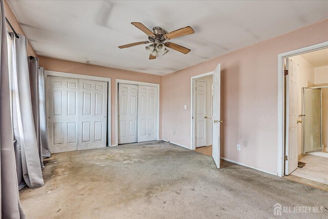 unfurnished bedroom with light carpet, ceiling fan, two closets, and ensuite bath