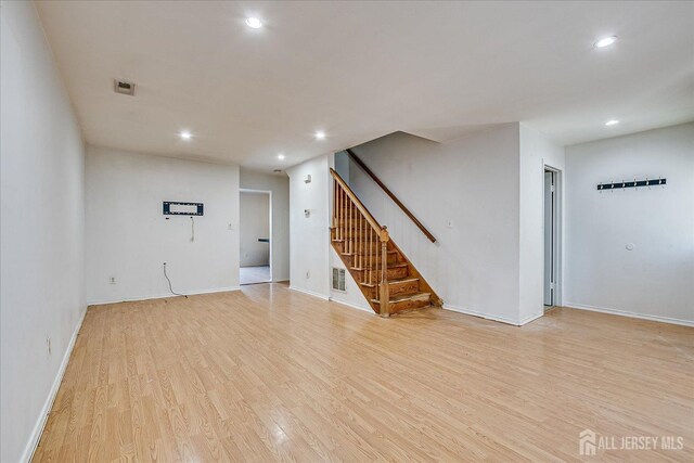 empty room with light hardwood / wood-style flooring