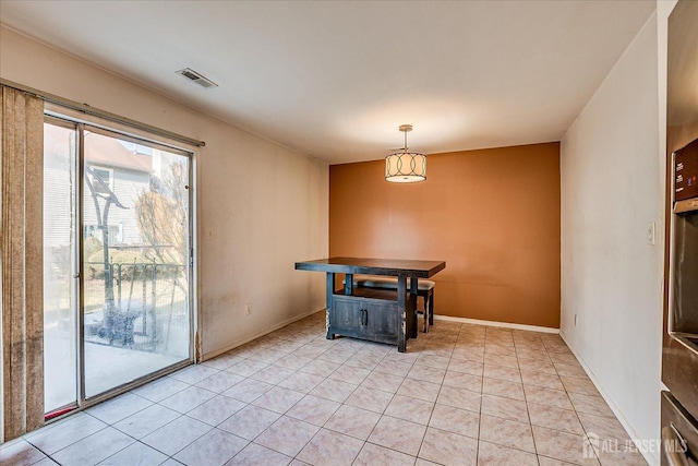 unfurnished dining area featuring light tile patterned floors