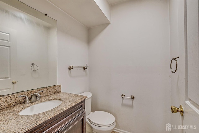 bathroom featuring toilet and vanity