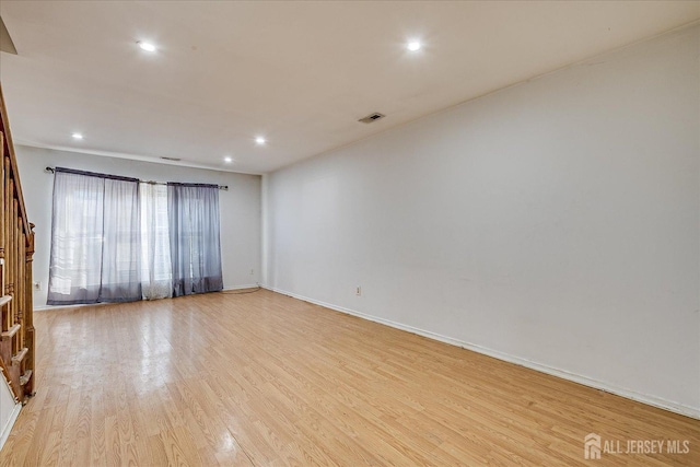 spare room featuring light hardwood / wood-style floors