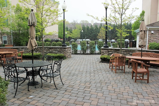 view of patio / terrace featuring fence and outdoor dining space