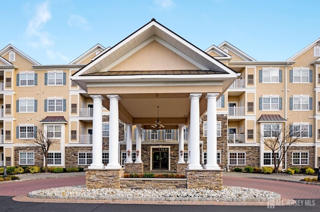 view of building exterior featuring curved driveway
