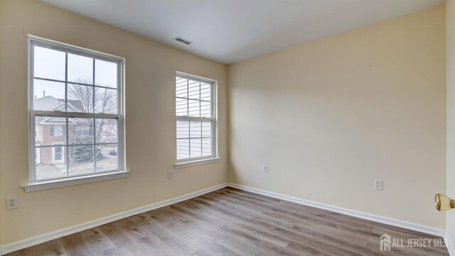 spare room with light hardwood / wood-style floors