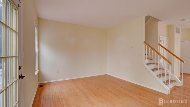 unfurnished room with light wood-type flooring