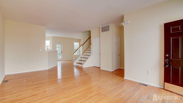 unfurnished room with light wood-type flooring