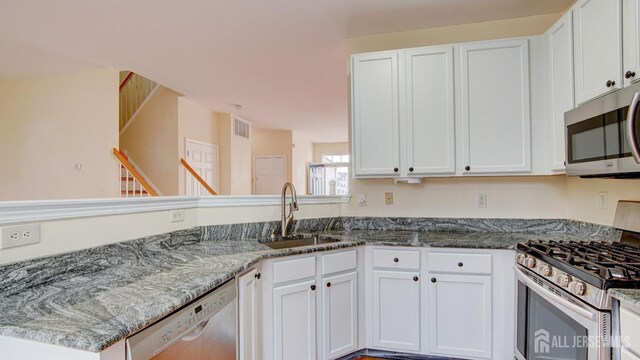 kitchen with white cabinetry, appliances with stainless steel finishes, and sink