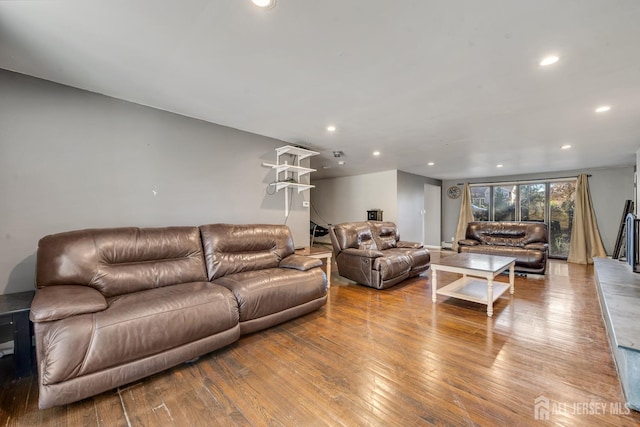 living room with wood-type flooring and recessed lighting