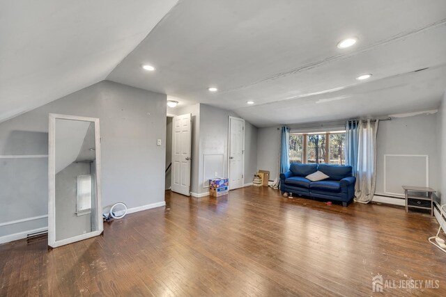 sitting room featuring vaulted ceiling and dark wood-type flooring