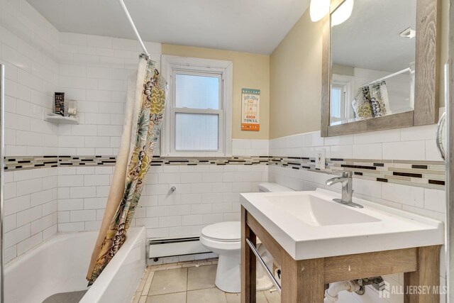 full bathroom with tile patterned flooring, a baseboard heating unit, tile walls, shower / bath combination with curtain, and toilet