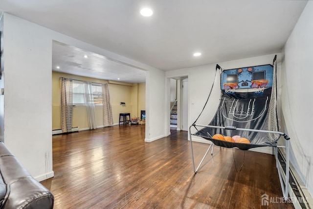 rec room featuring a baseboard heating unit, recessed lighting, baseboards, and wood finished floors