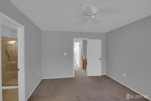 unfurnished bedroom with connected bathroom, light colored carpet, and ceiling fan