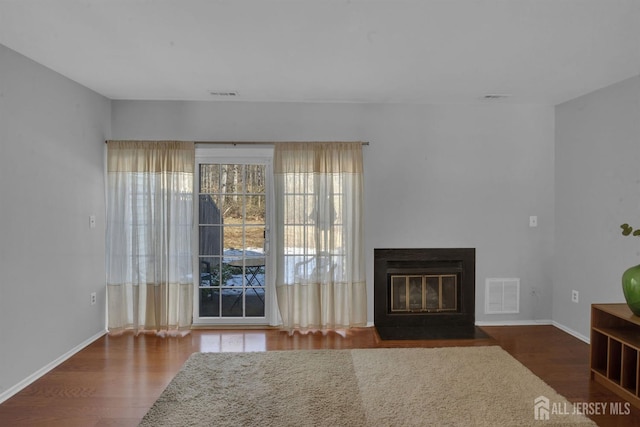 unfurnished living room with dark hardwood / wood-style floors