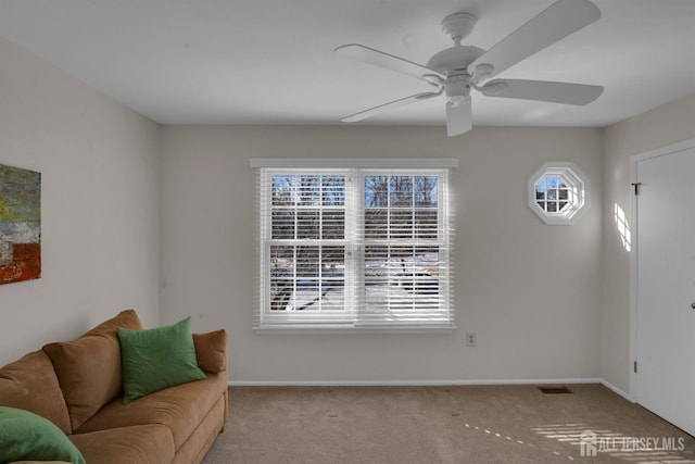 living room featuring plenty of natural light, light colored carpet, and ceiling fan