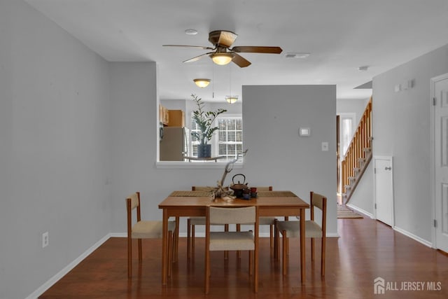 dining area with ceiling fan and dark hardwood / wood-style flooring