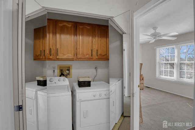 washroom featuring cabinets, ceiling fan, light colored carpet, and washer and clothes dryer