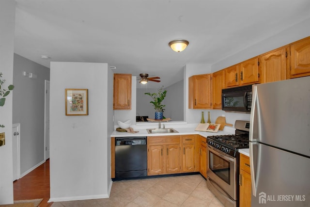 kitchen featuring ceiling fan, sink, and black appliances