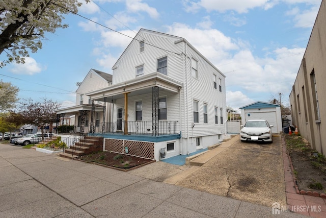 207 S Broadway, South Amboy, NJ 08879 - view of front of house featuring a porch, driveway, and a detached garage