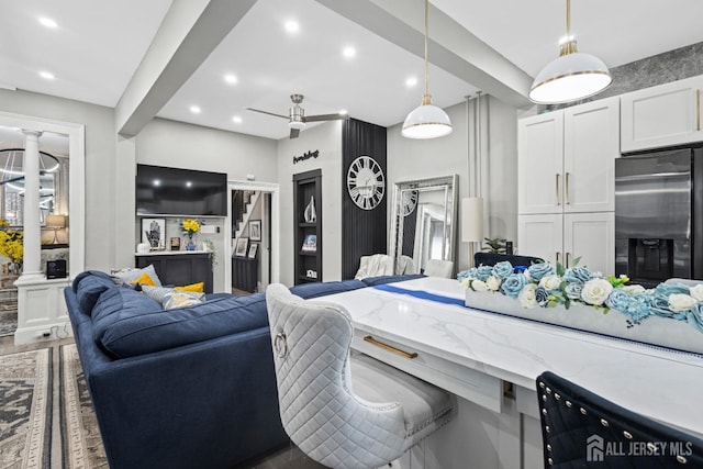 207 S Broadway, South Amboy, NJ 08879 - kitchen featuring stainless steel refrigerator with ice dispenser, light stone countertops, open floor plan, pendant lighting, and white cabinets